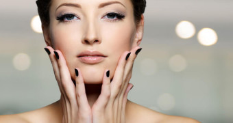 Portrait of a beautiful young woman with black nails