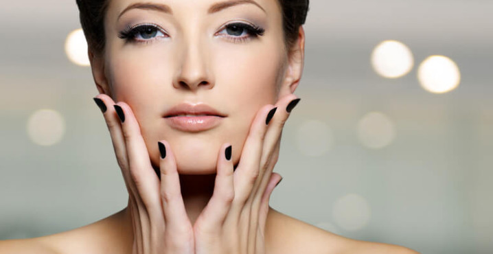 Portrait of a beautiful young woman with black nails