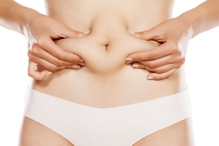woman pinching her stomach